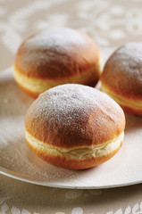 Group of fresh donuts covered with sugar powder