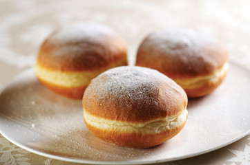 Group of fresh donuts covered with sugar powder