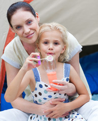 Mother and daughter  Blowing Bubbles