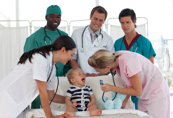 Doctors taking care of a young child