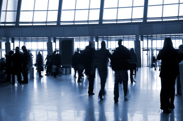 People in a modern architectural interior. Tint blue