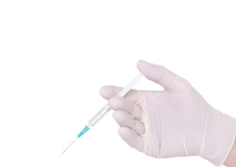 Syringe in a hand in medical gloves, ready for injection
