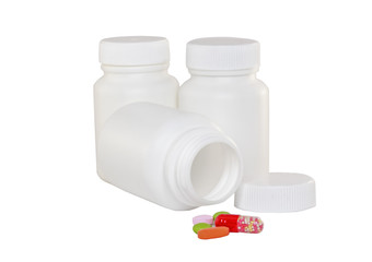 White medicine bottles with pills. Isolated