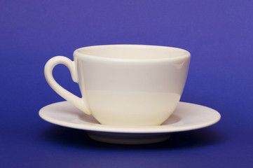 White cup isolated on the blue background