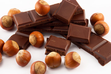 slices of chocolate and nuts on white background