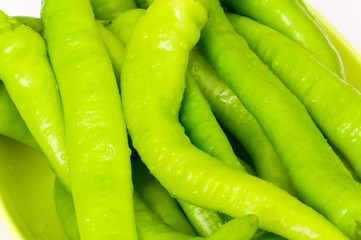 Many green hot peppers arranged at the market
