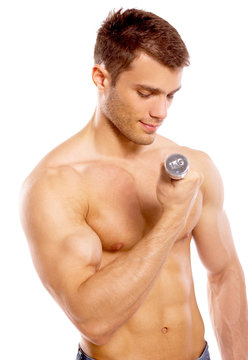 Muscular and tanned male during excersing with dumbbells