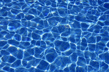 Blue water texture, tiles pool in sunny day