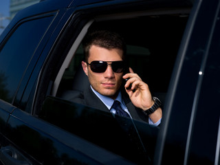 Portrait of business man in black limo