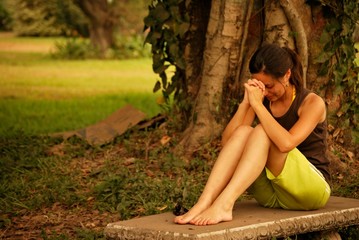 Hispanic woman praying outside - Powered by Adobe