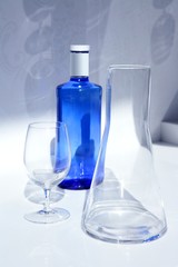 Blue water bottle with glass, transparent shadow