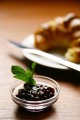 Fototapeta na wymiar Blueberry jam and croissant