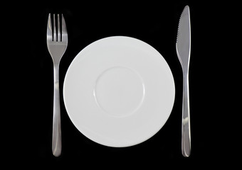 Fork, knife,  plate on black   background