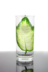 Glass of clean water with green leaf. Isolated