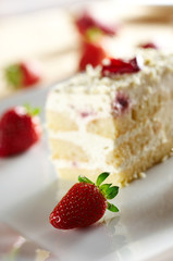 Tiramisu cake with strawberry on white plate