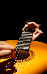 musician playing spanish style guitar