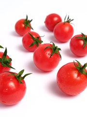 Cherry tomatoes forming lines on white background