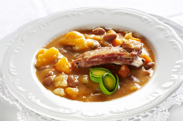 Vegetable soup with pork meat and green leaves of onion