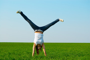 young woman doing cartwheel
