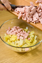 Addition of boiled wurst in salad
