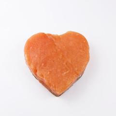 heart shaped salmon fillet on a white background
