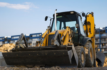 Excavator with a backhoe on the construction area