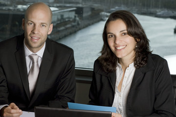 Two Businesspeople in front of a harbour