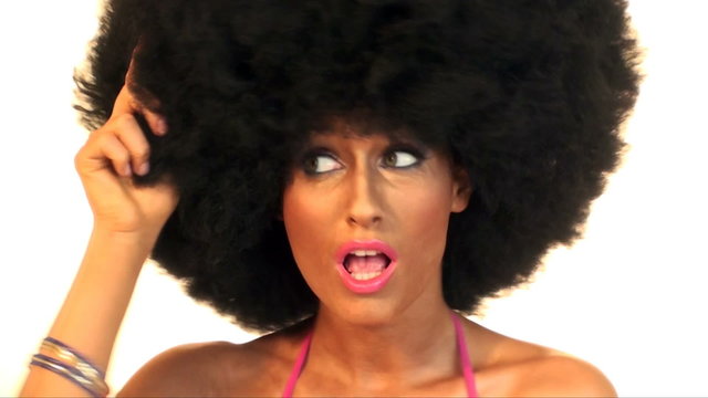Young beautiful woman is dancing in with afro hair