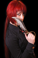 Young girl with long red hair and knife near her mouth