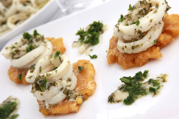 Calamari in garlic sauce over toasted plantain
