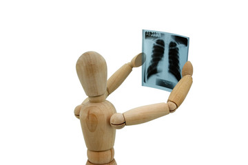 Wooden man looking at x-ray image on white background
