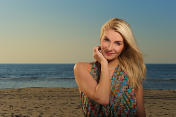Fototapeta na wymiar Beautiful woman on a beach at sunset