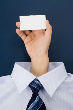hand holding a blank business card