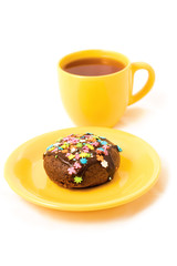 chocolate cake on the yellow plate and cup of tea