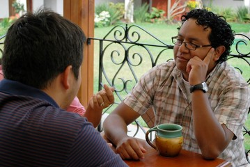 HIspanic man chatting at a cafe