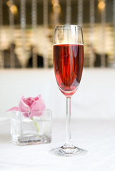 red alcohol cocktail in glass with orchid