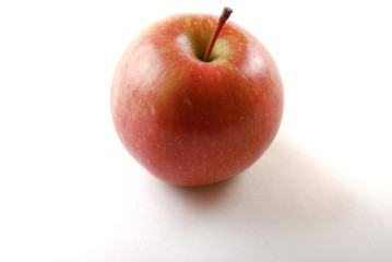 Fototapeta na wymiar Ripe red apple on a white background with a tail.