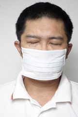 Asian man in medical mask portrait eyes closed