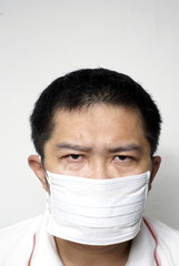 Serious asian man in medical mask portrait