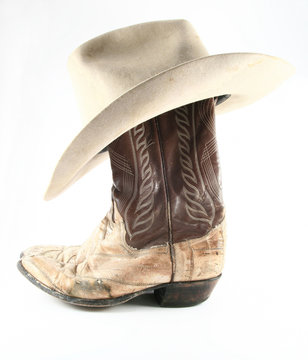Old cowboy boots and hat side view