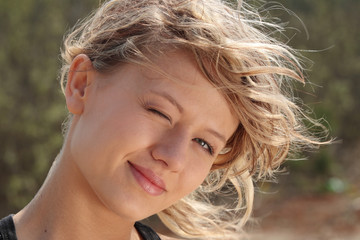 Blond fitness girl in wind portrait