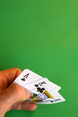ace and king clubs in the hand on green background ...