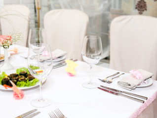 Modern tableware and glasses on a table