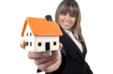 woman holding a small house in her hand