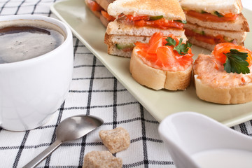 salmon sandwiches and a cup of coffee
