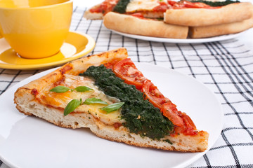 slices of vegetable pizza and a cup