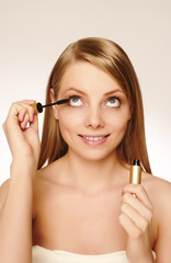 Fototapeta premium Pretty woman applying make up.