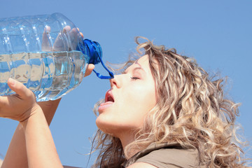 Thirsty blond woman on desert