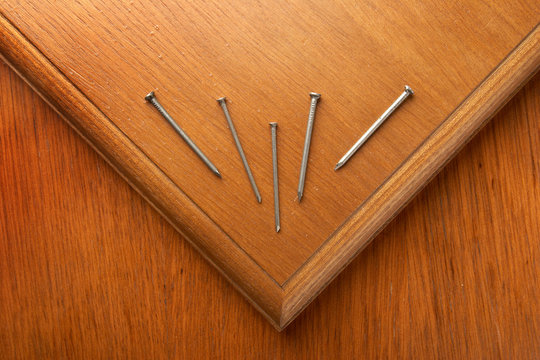 The nails lying on the wooden panel