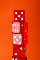 Red dice stack against orange background